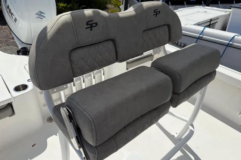 Slide: The Image of 2023 Sea Pro 228 Bay boat seating with gray upholstery and logo detail. - 13