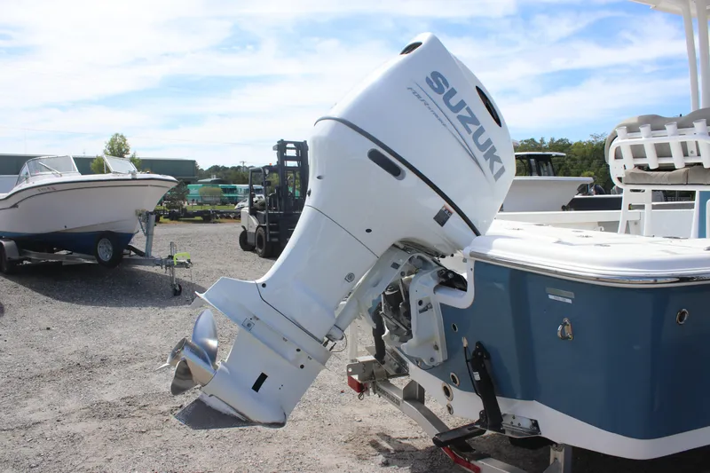 Slide: The Image of 2023 Sea Pro 228 Bay boat with Suzuki outboard motor in a marina setting. - 4