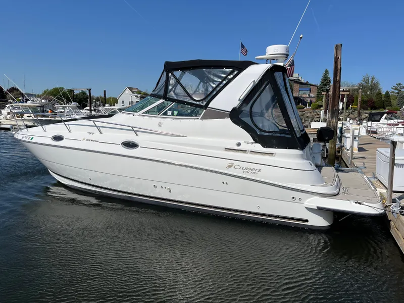 Slide: The Image of 2001 Cruisers Yachts 2870 Express docked at marina, side view. - 4