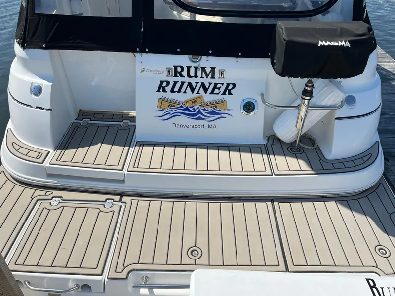 Slide: The Image of 2001 Cruisers Yachts 2870 Express boat with "Rum Runner" name, docked in Danversport, MA. - 6