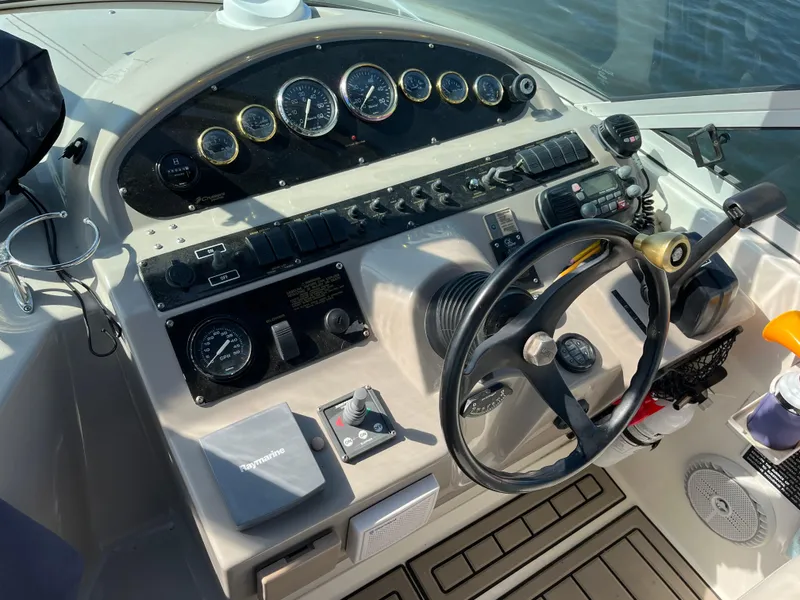 Slide: The Image of 2001 Cruisers Yachts 2870 Express helm with gauges and steering wheel. - 12