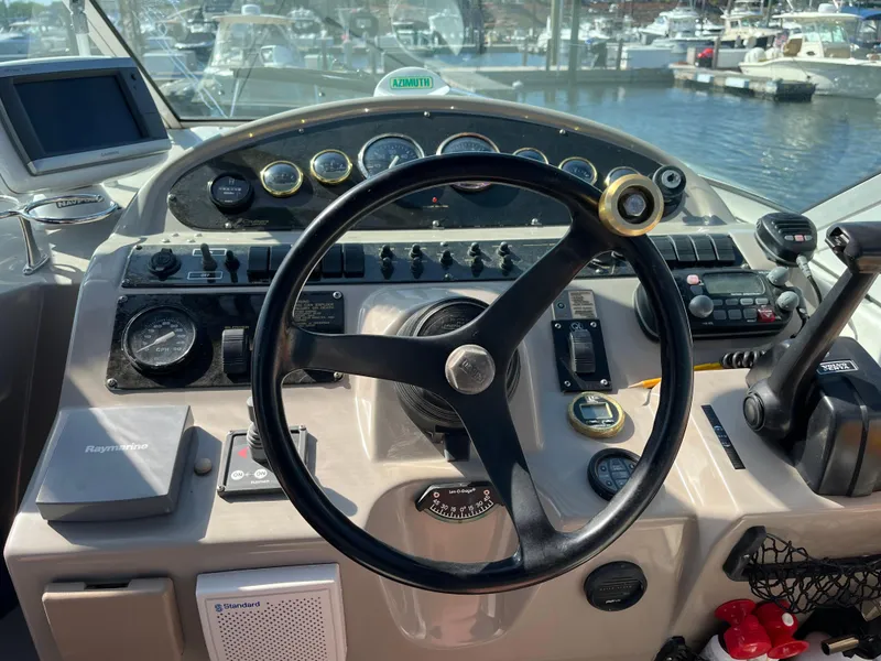 Slide: The Image of 2001 Cruisers Yachts 2870 Express helm with steering wheel and control panel. - 15