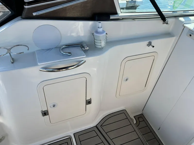 Slide: The Image of 2001 Cruisers Yachts 2870 Express interior with sink, storage compartments, and non-slip flooring. - 16