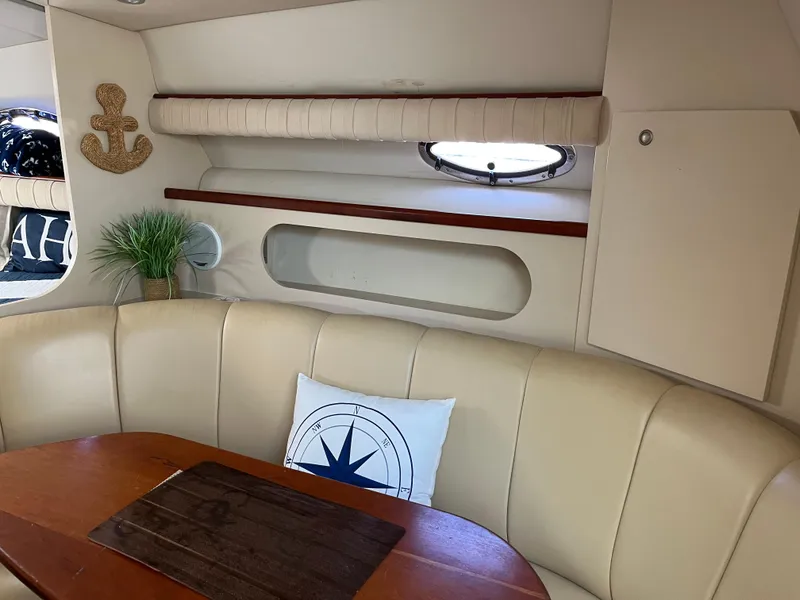 Slide: The Image of Interior of 2001 Cruisers Yachts 2870 Express with beige seating and nautical decor. - 19