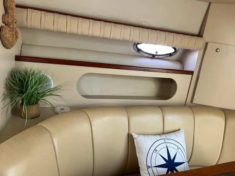 Slide: The Image of Interior of 2001 Cruisers Yachts 2870 Express with beige seating and nautical-themed decor. - 23