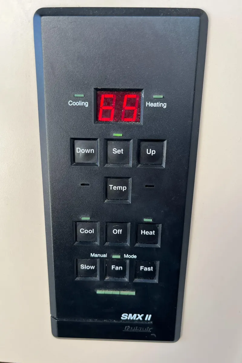 Slide: The Image of Control panel of a 2001 Cruisers Yachts 2870 Express, featuring temperature and fan settings. - 28