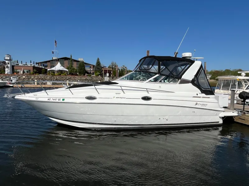 Slide: The Image of 2001 Cruisers Yachts 2870 Express docked in a marina under clear blue skies. - 5