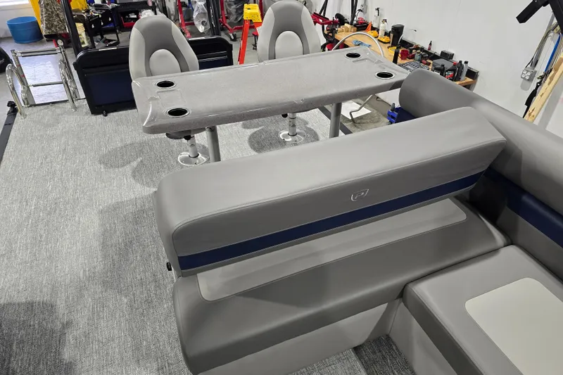 Slide: The Image of Interior of 2025 Premier 250 Sunsation RS boat with gray seating and table. - 21