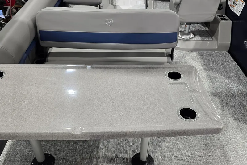 Slide: The Image of 2025 Premier 250 Sunsation RS boat interior with table and seating, featuring cup holders. - 25
