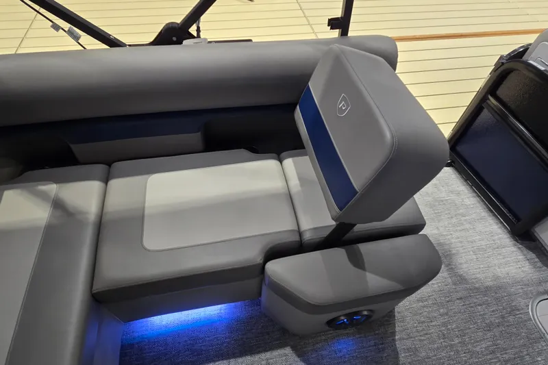 Slide: The Image of 2025 Premier 250 Sunsation RS boat interior with gray seating and blue LED lighting. - 30