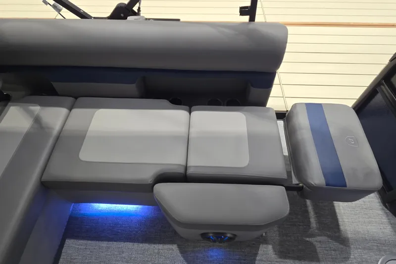 Slide: The Image of 2025 Premier 250 Sunsation RS boat interior with gray seating and blue LED lighting. - 31