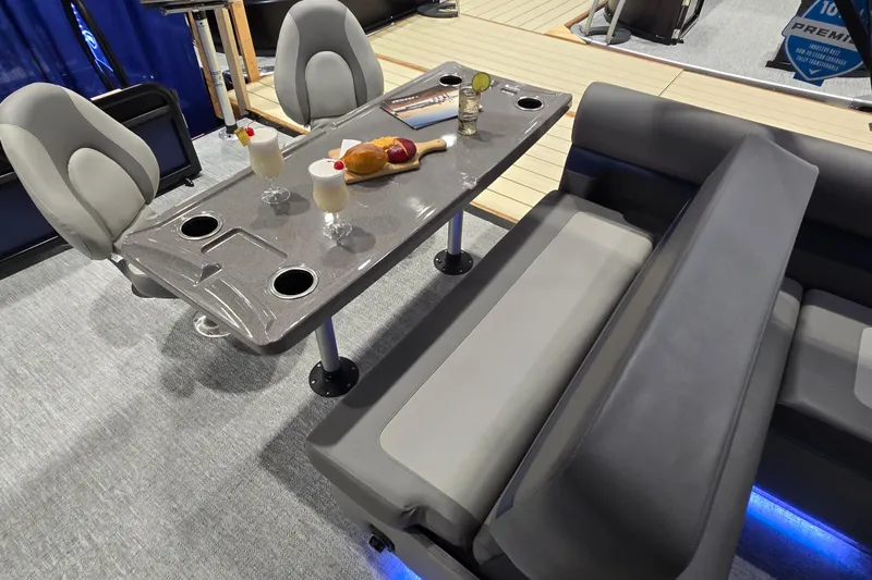 Slide: The Image of 2025 Premier 250 Sunsation RS interior with seating, table, and drinks. - 32