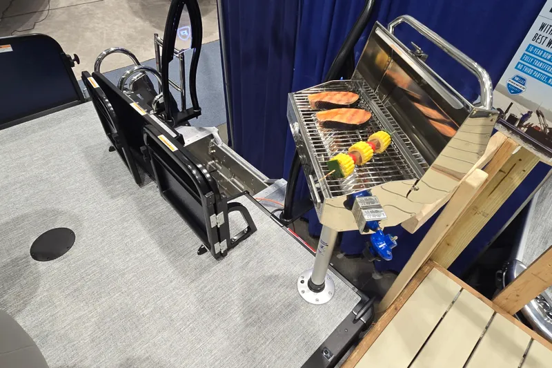 Slide: The Image of Grill setup on 2025 Premier 250 Sunsation RS boat with salmon and skewers. - 35