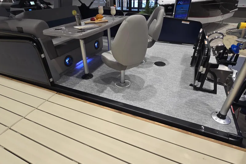 Slide: The Image of 2025 Premier 250 Sunsation RS boat interior with seating, table, and ambient lighting. - 37