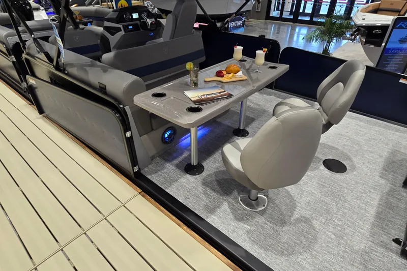 Slide: The Image of 2025 Premier 250 Sunsation RS interior with table, chairs, and refreshments. - 38