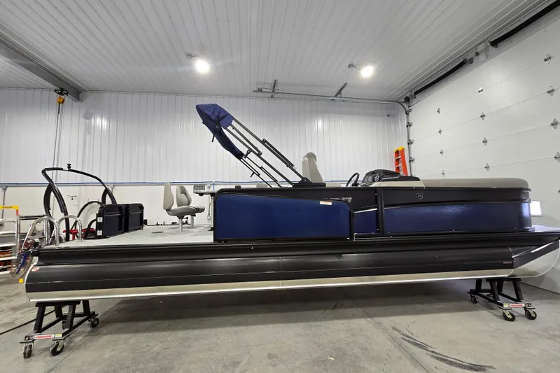 Slide: The Image of 2025 Premier 250 Sunsation RS pontoon boat in a spacious indoor garage. - 4