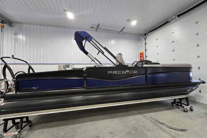 Slide: The Image of 2025 Premier 250 Sunsation RS pontoon boat in a garage setting. - 5