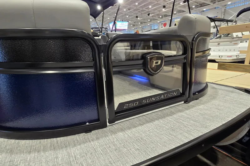 Slide: The Image of 2025 Premier 250 Sunsation RS pontoon boat interior at a showroom display. - 7