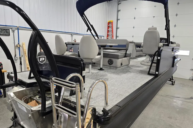 Slide: The Image of 2025 Premier 250 Sunsation RS pontoon boat interior in a garage setting. - 9
