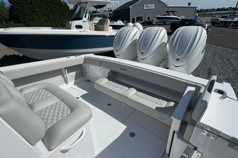 Slide: The Image of 2026 Jupiter 34 boat with luxurious seating and powerful outboard engines. - 13