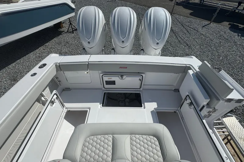 Slide: The Image of 2026 Jupiter 34 boat with triple outboard engines, spacious deck, and modern seating. - 14