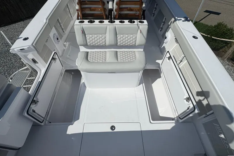 Slide: The Image of 2026 Jupiter 34 boat interior with white seating and open storage compartments. - 16