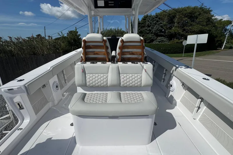 Slide: The Image of Interior of 2026 Jupiter 34 boat with cushioned seating and cup holders. - 19