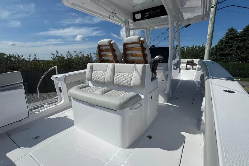 Slide: The Image of 2026 Jupiter 34 boat interior with luxurious seating and modern design under a clear sky. - 20