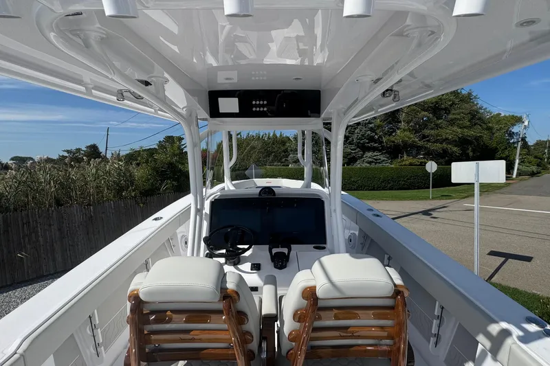 Slide: The Image of 2026 Jupiter 34 boat interior with dual seats and modern dashboard. - 23