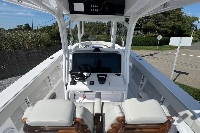 Slide: The Image of 2026 Jupiter 34 boat cockpit with modern steering and navigation system. - 26
