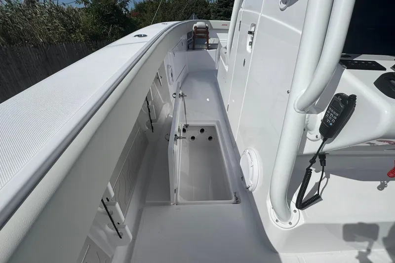 Slide: The Image of 2026 Jupiter 34 boat deck with open storage compartment and communication device. - 30