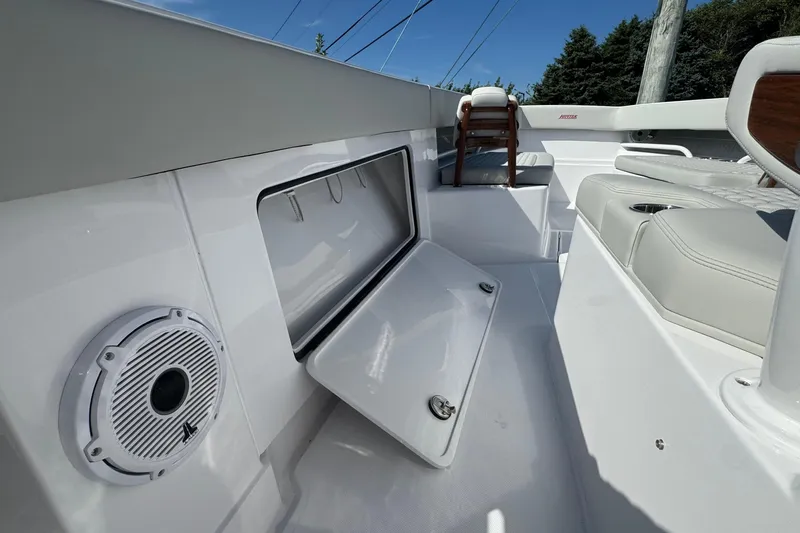 Slide: The Image of 2026 Jupiter 34 boat interior with open storage compartment and speaker. - 31