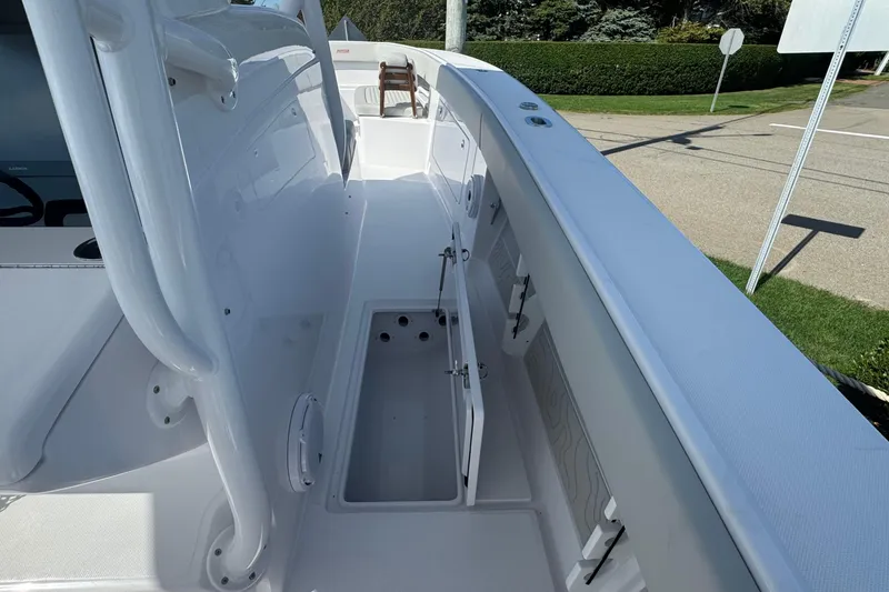 Slide: The Image of 2026 Jupiter 34 boat deck with open storage compartment, showcasing sleek design. - 33