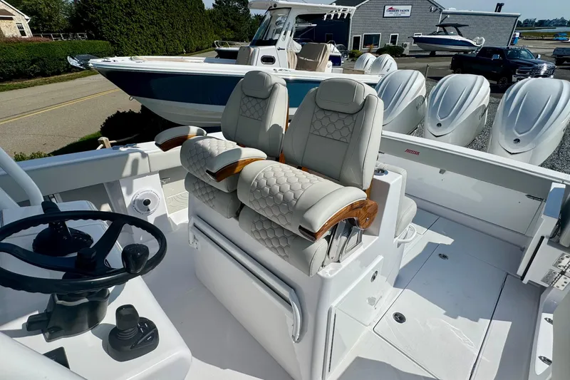 Slide: The Image of Luxury seating on 2026 Jupiter 34 boat with modern steering and controls. - 35