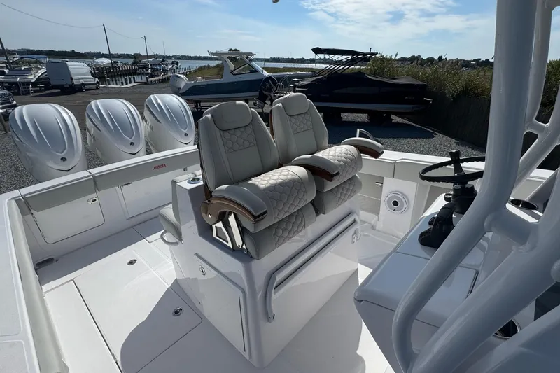 Slide: The Image of 2026 Jupiter 34 boat interior with luxurious seating and multiple outboard engines. - 36