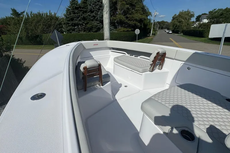 Slide: The Image of 2026 Jupiter 34 boat interior with cushioned seating and sleek design. - 38
