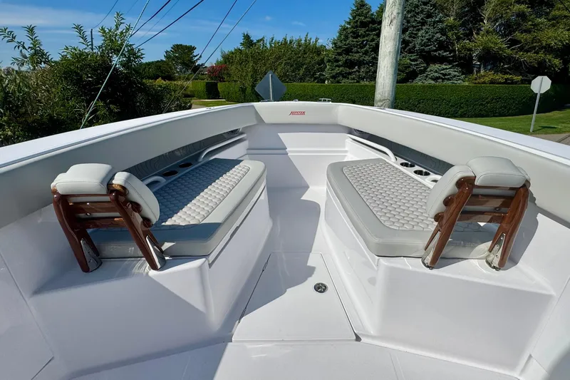 Slide: The Image of Front seating area of a 2026 Jupiter 34 boat with cushioned benches. - 39