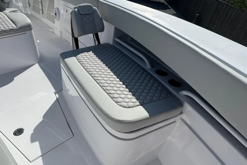 Slide: The Image of 2026 Jupiter 34 boat interior with cushioned seating and cup holders. - 44