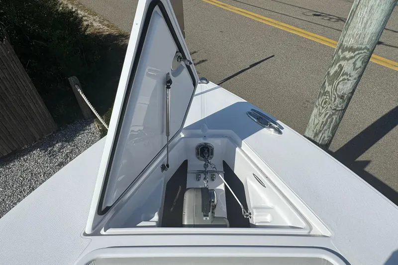 Slide: The Image of Open anchor compartment on 2026 Jupiter 34 boat, showing chain and mechanism. - 45