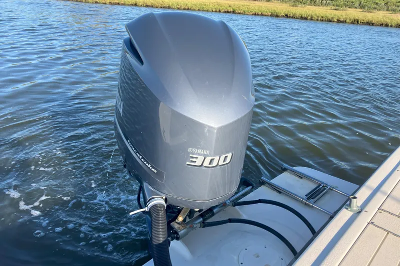 Slide: The Image of Yamaha 300 outboard motor on 2001 Parker 2520 Sport Cabin boat, water background. - 10