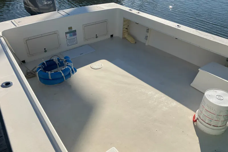 Slide: The Image of 2001 Parker 2520 Sport Cabin boat deck with storage compartments and safety equipment. - 11