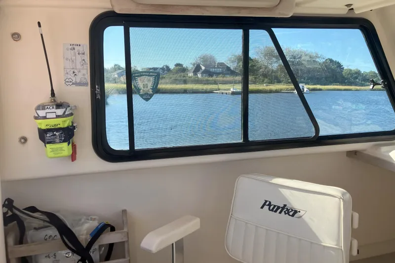 Slide: The Image of Interior view of 2001 Parker 2520 Sport Cabin boat with window overlooking water. - 12