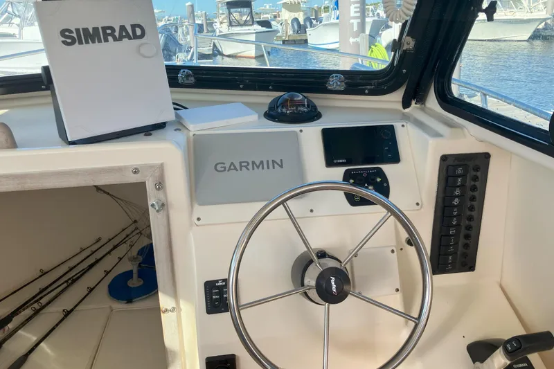 Slide: The Image of 2001 Parker 2520 Sport Cabin helm with Garmin and Simrad navigation systems. - 15