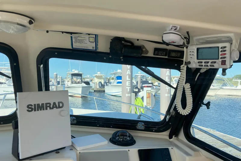 Slide: The Image of Interior view of a 2001 Parker 2520 Sport Cabin boat with navigation equipment. - 16