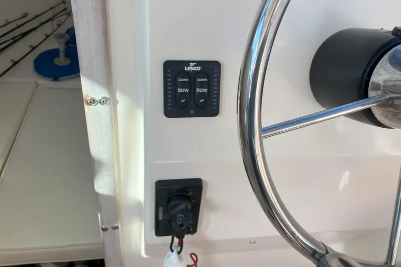 Slide: The Image of Steering wheel and controls of a 2001 Parker 2520 Sport Cabin boat. - 21