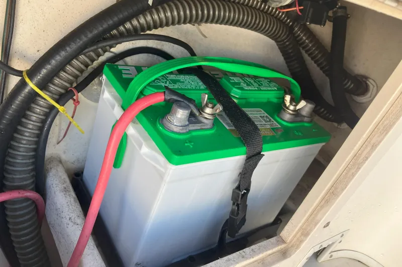 Slide: The Image of Battery compartment of 2001 Parker 2520 Sport Cabin boat with green-top battery. - 30