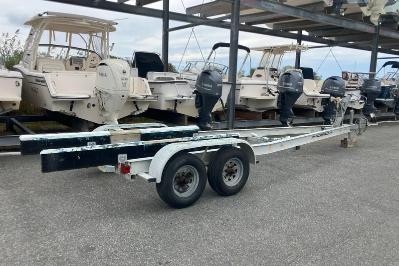 Slide: The Image of Boat trailer near Parker 2520 Sport Cabin, 2001 model, in a storage area. - 36