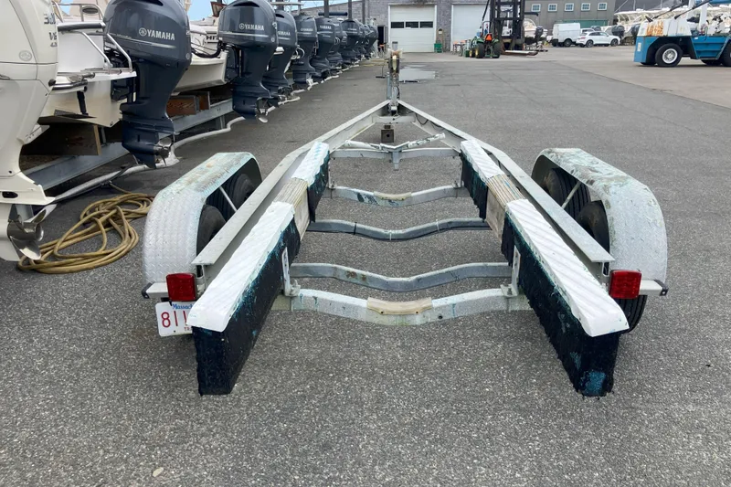 Slide: The Image of Boat trailer for 2001 Parker 2520 Sport Cabin, parked in a marina lot. - 37