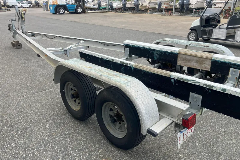 Slide: The Image of Boat trailer for 2001 Parker 2520 Sport Cabin, parked in a marina lot. - 38