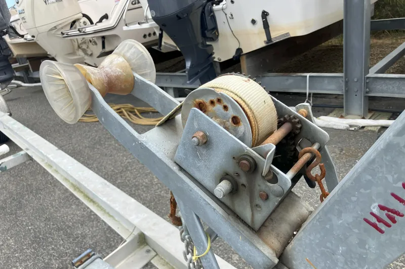 Slide: The Image of Rusty boat trailer winch near Parker 2520 Sport Cabin, 2001 model, with Yamaha outboard engines. - 44